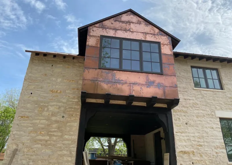Copper metal panel facade on a stone building for Metal Roof Coating in Oak Grove